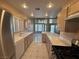 Bright kitchen featuring tile countertops, stainless steel appliances, and ample cabinet space at 3136 Jane Austin Ave, North Las Vegas, NV 89031