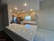 Kitchen featuring tile flooring and countertops, stainless steel refrigerator and ample lighting at 3136 Jane Austin Ave, North Las Vegas, NV 89031