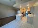 Open concept, connecting living area and kitchen with tile flooring and abundant lighting at 3136 Jane Austin Ave, North Las Vegas, NV 89031