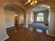 Open-concept living room featuring archways, hardwood floors, and a cozy fireplace at 3136 Jane Austin Ave, North Las Vegas, NV 89031