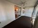Enclosed sunroom with textured walls, sliding glass door leading to interior, ceiling fan and neutral flooring at 3136 Jane Austin Ave, North Las Vegas, NV 89031