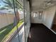 Enclosed sunroom offering a view of the backyard featuring mature palm tree and block fence at 3136 Jane Austin Ave, North Las Vegas, NV 89031
