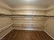 Spacious walk-in closet with shelving and laminate wood flooring at 3136 Jane Austin Ave, North Las Vegas, NV 89031