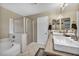 Bathroom with double sinks, tile flooring, and separate glass door shower and tub at 3232 Brayton Mist Dr, North Las Vegas, NV 89081