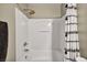Bathroom with tub and shower featuring modern fixtures and stylish shower curtain at 3232 Brayton Mist Dr, North Las Vegas, NV 89081