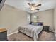 This cozy bedroom features a ceiling fan, neutral walls, and natural light from the window at 3232 Brayton Mist Dr, North Las Vegas, NV 89081