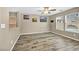 Spacious bedroom with wood-look tile, natural light, and contemporary decor at 3232 Brayton Mist Dr, North Las Vegas, NV 89081