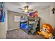 Charming ' bedroom features a bunk bed, carpeted floor, and ample space for playing at 3232 Brayton Mist Dr, North Las Vegas, NV 89081