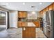 Modern kitchen with stainless steel appliances, island, and sleek backsplash at 3232 Brayton Mist Dr, North Las Vegas, NV 89081