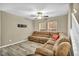 Inviting living room with plush brown sofa and wood-look tile flooring at 3232 Brayton Mist Dr, North Las Vegas, NV 89081