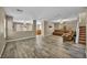 Open concept living room with wood floors and a ceiling fan and view into other rooms at 3232 Brayton Mist Dr, North Las Vegas, NV 89081