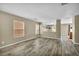Open concept living room with wood look floors, neutral walls, and plenty of natural light at 3232 Brayton Mist Dr, North Las Vegas, NV 89081