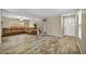 Open living area with wood-look tile flooring, sofa, and staircase access at 3232 Brayton Mist Dr, North Las Vegas, NV 89081