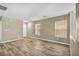 Bright living room features neutral walls and modern wood-look tile flooring at 3232 Brayton Mist Dr, North Las Vegas, NV 89081
