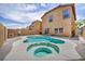 A full view of the backyard pool and jacuzzi along with the 2 story home behind it at 3232 Brayton Mist Dr, North Las Vegas, NV 89081