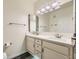 Bright bathroom featuring a dual sink vanity with white cabinets and modern lighting fixtures at 3253 Mystic Ridge Ct, Las Vegas, NV 89129