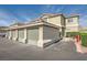 Attached garages with gray doors and well-maintained landscaping in a residential area at 3253 Mystic Ridge Ct, Las Vegas, NV 89129
