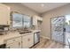 Bright kitchen boasts stainless steel appliances, stone countertops, and outdoor access at 3253 Mystic Ridge Ct, Las Vegas, NV 89129