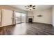 Bright living room with wood flooring, fireplace, and sliding glass doors to a patio at 3253 Mystic Ridge Ct, Las Vegas, NV 89129
