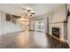 Cozy living area with a fireplace, wood floors, and open access to the kitchen at 3253 Mystic Ridge Ct, Las Vegas, NV 89129