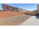 Low maintenance backyard with gravel, a brick wall and paver stones at 334 E Neal Ave, Las Vegas, NV 89183