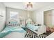 Cozy bedroom with two twin beds, stylish decor, and ample natural light at 334 E Neal Ave, Las Vegas, NV 89183