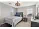 Comfortable bedroom featuring a queen bed, modern lighting, and neutral tones at 334 E Neal Ave, Las Vegas, NV 89183