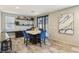 Modern dining area with a marble-top table, blue velvet chairs, and contemporary decor and lighting at 334 E Neal Ave, Las Vegas, NV 89183