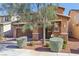 Inviting two-story home with a manicured yard and a covered porch, complemented by shade trees at 334 E Neal Ave, Las Vegas, NV 89183