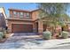 Charming two-story home with a brick-accented facade, a two-car garage, and landscaped front yard at 334 E Neal Ave, Las Vegas, NV 89183