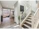 Spacious foyer with staircase, open to living areas, featuring wood-look tile flooring throughout at 334 E Neal Ave, Las Vegas, NV 89183