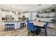 Open kitchen with stainless steel appliances, white cabinets, granite countertops, and counter seating at the island at 334 E Neal Ave, Las Vegas, NV 89183