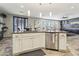 Open kitchen island with granite countertops, stainless steel dishwasher, and view into living space at 334 E Neal Ave, Las Vegas, NV 89183