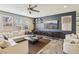 Comfortable living room with a modern ceiling fan, stone floors, and a plush sectional sofa at 334 E Neal Ave, Las Vegas, NV 89183