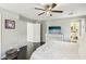 Well-lit main bedroom with hardwood floors, white furniture, and a glimpse into the ensuite bathroom at 334 E Neal Ave, Las Vegas, NV 89183