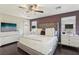 Spacious main bedroom features a tufted headboard, hardwood floors, and ample natural light at 334 E Neal Ave, Las Vegas, NV 89183