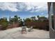 An outdoor patio with desert landscaping, rock perimeter, table, and chairs at 3440 Crystal Tower St, Las Vegas, NV 89129