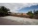 Concrete backyard patio featuring a block fence with mature landscaping at 3440 Crystal Tower St, Las Vegas, NV 89129