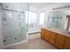 Bathroom featuring a glass shower, a large tub, and dual sinks, offering a luxurious bathing experience at 3440 Crystal Tower St, Las Vegas, NV 89129