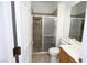 Bathroom with tiled shower, toilet, and wooden vanity with a white countertop at 3440 Crystal Tower St, Las Vegas, NV 89129