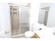 Bathroom showcasing tiled shower with glass door, toilet, and wooden vanity with white counter at 3440 Crystal Tower St, Las Vegas, NV 89129