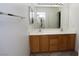 Bathroom with double sinks, vanity, and a large mirror complemented by sleek, modern fixtures at 3440 Crystal Tower St, Las Vegas, NV 89129