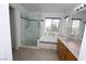 Modern bathroom boasts a glass shower, soaking tub and a vanity, all enhanced by natural light and neutral tile at 3440 Crystal Tower St, Las Vegas, NV 89129