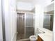 Bathroom featuring glass doored shower, toilet, sink, and mirror at 3440 Crystal Tower St, Las Vegas, NV 89129
