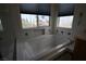 Bright bathroom featuring a white bathtub with jets and a decorative tiled backsplash and a neighborhood view at 3440 Crystal Tower St, Las Vegas, NV 89129
