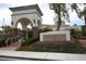 Welcoming Shadow Hills Club entrance with stone accents, arched entry and lush landscaping providing a grand sense of arrival at 3440 Crystal Tower St, Las Vegas, NV 89129