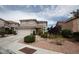 Two-story home featuring desert landscaping, a two-car garage, and a tile roof on a sunny day at 3440 Crystal Tower St, Las Vegas, NV 89129