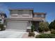 Two-story home featuring desert landscaping, a two-car garage, and a tile roof under a clear blue sky at 3440 Crystal Tower St, Las Vegas, NV 89129