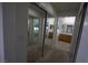 Hallway featuring access to bathrooms and a closet with mirrored sliding doors at 3440 Crystal Tower St, Las Vegas, NV 89129