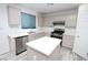Kitchen with an island, stainless steel appliances, and plentiful cabinet space at 3440 Crystal Tower St, Las Vegas, NV 89129